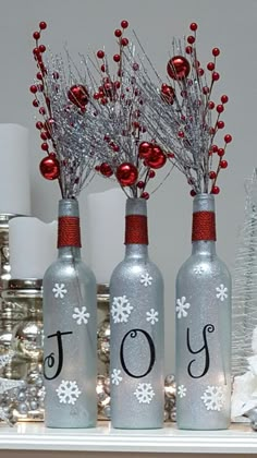 three wine bottles with christmas decorations on them