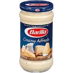 a jar of creamy alfredo with bread on the bottom and dressing in the middle