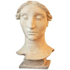 a statue of a woman's head with her eyes closed