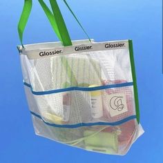 a clear shopping bag hanging from the side of a blue sky with two gusier bags attached to it