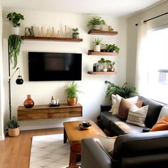 a living room with two couches and a flat screen tv mounted on the wall