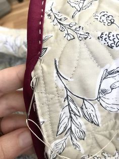 someone is stitching on the side of a piece of fabric that has been sewn together