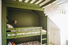 a bunk bed in a room with green walls