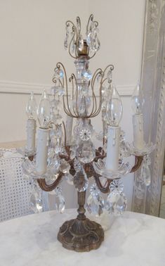 an antique chandelier with several candles on it