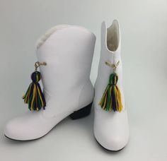 Women's White Parade Booties with Tassels Mardi Gras Majorette Marching Boots (Adult) Upgrade your marching game with Mardi Gras Marching Boots (Adult). Made for comfort and durability, these boots will keep you marching in style during any parade or event. With a sleek design and high-quality construction, these boots are perfect for any marching band or performance group. Shop more from our shoes collection, here! Details Available in sizes 5 - 11 Color: White Yarn tassel detail Majorette Mard Mardi Gras Marching Boots, Sequin T Shirt Dress, Yarn Tassel, Sweet Grace, Mardi Gras Parade, One Piece & Sets, Wedding Guest Style, Body Glitter, Maxi Gown Dress