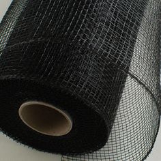 a roll of black wire mesh sitting on top of a table