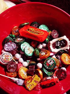 a red bowl filled with assorted candy