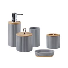 three pieces of bathroom accessories including soap dispenser and toothbrush holder