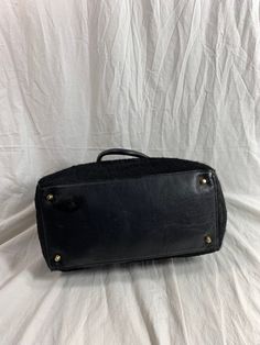 "Measurements are 14\" top wide, 10\"5 high, 5\"8 deep with two 48\" straps each side to side with a 8\" drop. On the interior there is one main compartment, unlined leather, back zipper pocket and a top magnetic closure. Bag is made of calf hair with black leather trim, gold tone hardware and chunky handles. Please note bag is not new and there are scuffs with some balding and bag is great for daily use and will last you for years to come. I WANT TO STRESS THAT THIS ITEM IS VINTAGE WHICH MEANS Leather Top Handle Bag With Lined Interior, Black Top Handle Bag With Leather Trim, Leather Shoulder Bag With Lined Interior For Shopping, Luxury Black Weekender Bag With Handles, Luxury Black Medium Bags, Luxury Medium Black Bags, Medium Luxury Black Bags, Medium Black Luxury Bags, Leather Shoulder Bag With Double Handle And Lined Interior