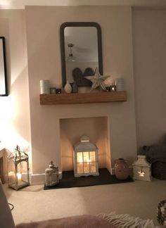 a living room filled with furniture and a fire place next to a wall mounted mirror