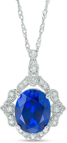 Zales Oval Lab-Created Blue Sapphire and 1/6 CT. T.W. Diamond Vintage-Style Vine Frame Pendant in 10K White Gold Elegant Royal Blue Jewelry With Brilliant Cut, Classic Necklace With Round Pendant And Intricate Design, Classic Royal Blue Diamond Jewelry, Classic Necklace With Intricate Round Pendant, Classic Necklaces With Intricate Round Pendant, Classic Sapphire Pendant Necklace, Classic Blue Necklace With Diamond Accents, Classic Sapphire Necklaces For Weddings, Classic Sapphire Necklace For Wedding