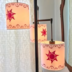 two lamps that are next to each other in front of a mirror on a wall