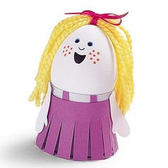 a toy doll with blonde hair and braids on it's head, wearing a purple dress