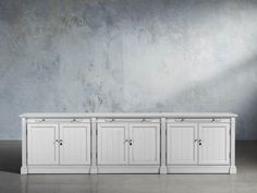 an empty room with three white cupboards