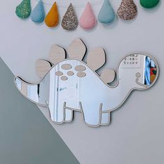 an elephant shaped mirror hanging on the side of a wall