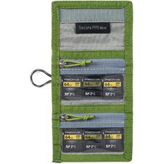 The highland green Mini Secure Pixel Pocket Rocket Memory Card Wallet from Think Tank Photo holds 4 CF or CFexpress cards, 6 SD cards, or multiple microSD cards. Its folding design features a secure hook-and-loop closure and clear zippered pockets for easy card identification and security. Sized to fit in your pocket or bag, it includes a removable security lanyard and belt attachment for convenient transport. Made from durable, weather-treated double-ripstop material, this wallet protects your cards from the elements. Functional Green Rectangular Wallet, Green Rfid Blocking Trifold Wallet For Travel, Functional Green Rectangular Cases, Functional Green Rectangular Case, Green Wallet With Interior Key Chain Holder For Travel, Green Rfid Blocking Trifold Wallet, Green Trifold Wallet With Rfid Blocking, Green Rectangular Trifold Wallet With Rfid Blocking, Functional Green Rectangular Organizer