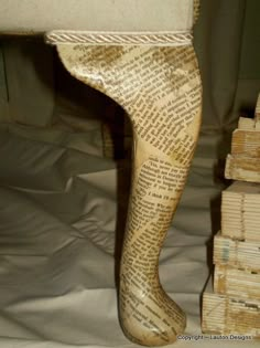 the legs of a wooden statue are made out of books