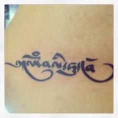 a tattoo with the word buddha written in cursive writing