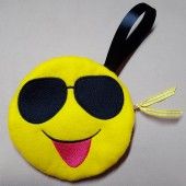 a yellow smiley face with sunglasses on it's head and a black lanyard