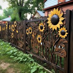 an iron fence with sunflowers painted on it