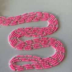 This uniquely and beautifully handcrafted. Women waist beads. Made with mixture of seeds and glass beads. Each strand is measured approximately 60 inches long.  Each purchase is 1 strand of waist bead of your choice  helps gets your waist snatched and beautifies your waist  Ready to ship. This is Tie on waist beads. Color of beads: Pink and silver. Size of beads 3mm. Materials used: beads/ friendly thread Pink Waist Beads With 108 Beads As A Gift, Multi-strand Beaded Waist Beads For Festival, Adjustable Pink Waist Beads With Spacer Beads, Bohemian Beaded Chain Waist Beads, Pink Spacer Beads For Festival, Festival Waist Beads With Round Beaded Chain, Pink Tiny Beads Waist Beads For Gift, Festival Waist Beads With Beaded Chain, Pink Bohemian Waist Beads With Colorful Beads