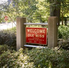 a welcome to olee miss sign is in the middle of some bushes and trees