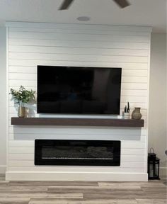 a flat screen tv mounted above a fireplace