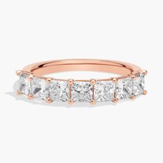 a rose gold ring with princess cut diamonds