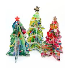 three christmas trees made out of colored paper