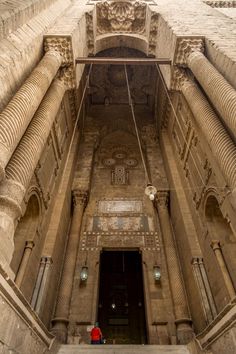 the entrance to an old building with stone columns