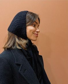 a woman wearing a black hat and coat