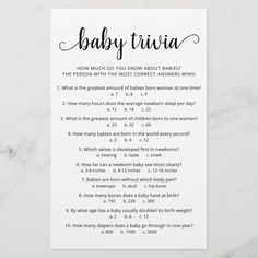 the baby trivia game is shown in black and white on a marble table top