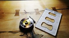 a metal object sitting on top of a wooden table