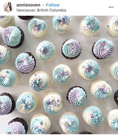 there are many cupcakes with blue and white frosting