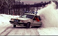 a car driving down a snow covered road