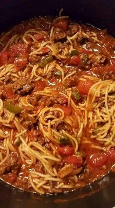 a large pot filled with spaghetti and meat