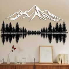 a wall decal with mountains, trees and water in front of the mountain range