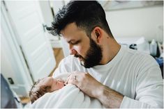 a man holding a baby in his arms