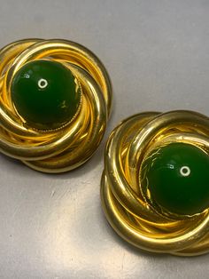 WONDERFUL HUGE VINTAGE 1980's Massive Gold Plated Green Stone Cabochon Clip On earrings Huge Big Bold Statement Runway Couture Glamour Xl  These earrings are big and Bold in size With Huge cabochons! Unsigned but of designer quality! Measurements: 4.5cm diameter, Cabochons are 2cm by 1.5cm up Condition: In ABOVE excellent vintage condition, The clips are secure and tight. Please look at the photos as they are truly representative of the condition of this amazing Clip On earrings. All our items a Vintage Cabochon Earrings For Evening, Vintage Metal Cabochon Earrings, Vintage Cabochon Metal Earrings, Luxury Green Oval Cabochon Earrings, Luxury Gold Cabochon Clip-on Earrings, Vintage Green Cabochon Earrings, Vintage Round Clip-on Earrings With Cabochon, Vintage Cabochon Clip-on Earrings, Vintage Gold Cabochon Clip-on Earrings