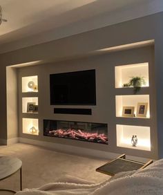 a living room with a couch, fireplace and entertainment center in the middle of it