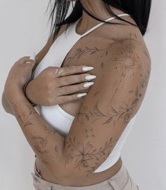 a woman with tattoos on her arms and chest