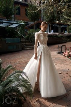 a woman in a white wedding dress standing on a brick walkway with her leg up