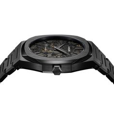 Black "Diamond-Like Carbon" is typically used on watch cases. While that's true of this D1 Milano timepiece, it's also used for the dial, as well. Rendered in black carbon with gold details, it sits inside a 40mm black DLC case, with black indices and black hour and minute hands driven by a Miyota 1L22 quartz movement. The watch sits on a case-matching black DLC stainless steel bracelet, giving the timepiece a low-key, stealthy look. Luxury Black Watches, Timeless Black Watch Accessories With Rectangular Dial, Timeless Black Watch With Rectangular Dial, Black Timeless Watch With Rectangular Dial, Black Watch Accessory With Skeleton Rectangular Dial, Black Watch Accessory With Skeleton Dial, Luxury Black Watch Accessories With Analog Display, Luxury Black Watch With Analog Display, Timeless Black Watch With Skeleton Dial