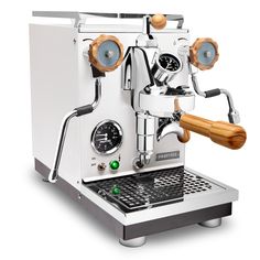 an espresso machine sitting on top of a counter next to a wooden handle