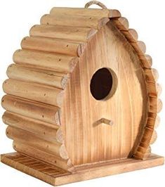 a wooden birdhouse with a hole in the roof