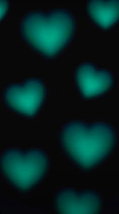 many green hearts are glowing in the dark