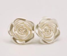 White rose bead earrings perfect for weddings, events or just casual wear. Simple elegance, a ivory white flat back resin rose bead is attached to stud earring backing. These earrings are perfect to pair with the School Spirit Necklace and the Wedding Rose Necklace. Materials -- Stud earring backs -- 1.9 cm White Flatback Resin Rose bead Resin Rose, Wedding Rose, Rose Stud Earrings, White Flat, Rose Necklace, Rose Wedding, Simple Elegance, Bead Earrings, School Spirit