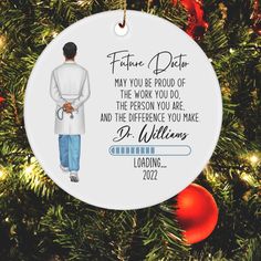 a personalized ornament for a doctor hanging on a christmas tree with ornaments around it