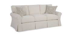 a white couch with two pillows on it's back and the arms folded down