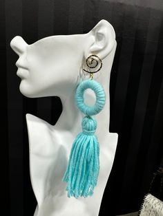 Made from dense, soft yarn, these statement earrings feature a bold ring and flowing tassel design. Available in multiple colors, they are perfect for adding a playful, yet sophisticated flair to any outfit. Trendy Tassel Fringe Drop Earrings, Trendy Tassel Drop Earrings, Trendy Tassel Earrings, Trendy Tassel Drop Earrings With Fringe, Chic Tassel Earrings, Trendy Spring Earrings With Tassels, Trendy Tassel Earrings For Spring, Chic Handmade Tassel Drop Earrings, Chic Dangle Tassel Earrings